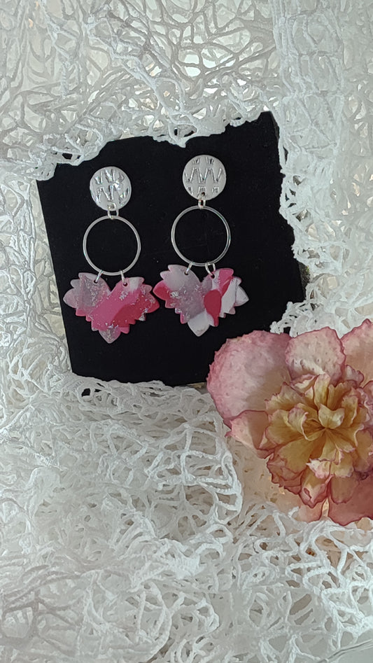 Handcrafted polymer clay earrings featuring a beautiful combination of pink, silver, and white colors. The unique design showcases a playful mix of shapes and textures, perfect for adding a touch of elegance to any outfit.